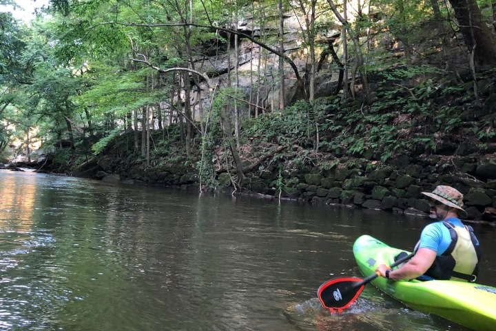 a person riding on the back of a boat in the water