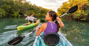 a little girl riding on a raft in a body of water