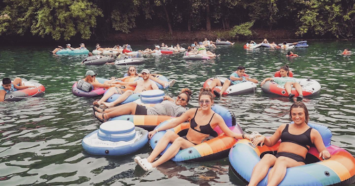 a group of people rowing a boat in the water