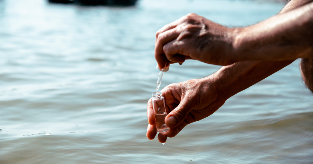 a person standing next to a body of water